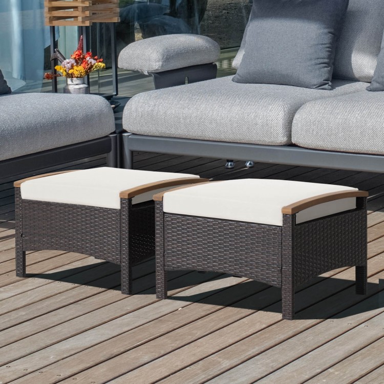 Set of 2 fade-resistant wicker patio ottomans with soft white cushions and acacia wood handles for versatile outdoor.