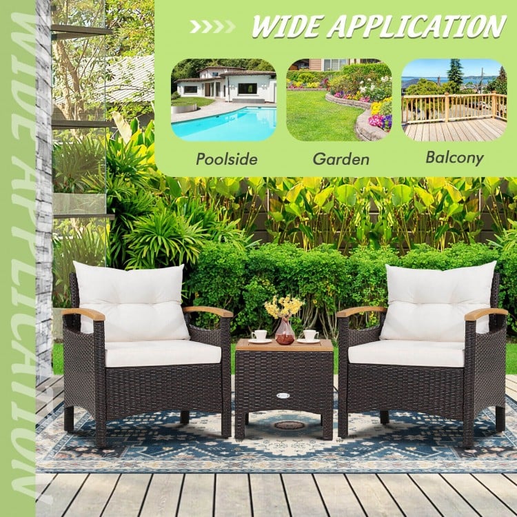 Patio rattan furniture set featuring two chairs and a table, with off-white cushions, ideal for outdoor use.
