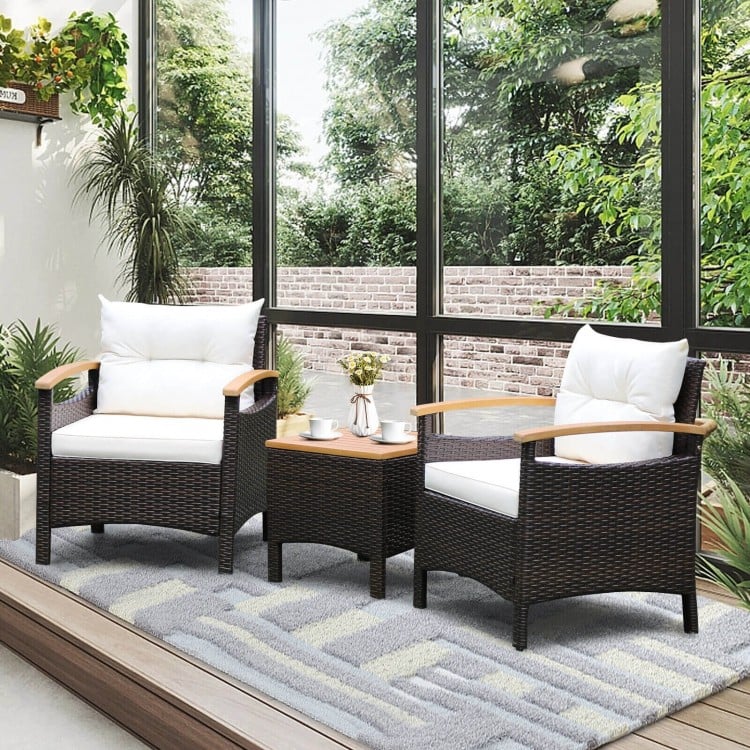 Two comfortable patio chairs with off-white cushions and a brown PE rattan frame, ideal for outdoor relaxation.