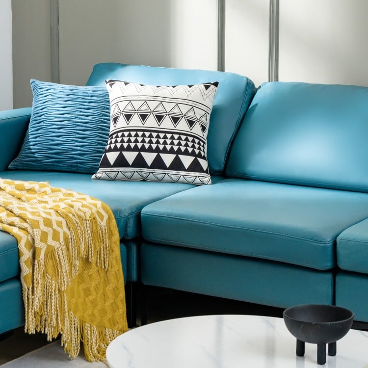 Modular L-shaped sectional sofa in blue with reversible chaise, featuring USB ports and decorative cushions for modern.