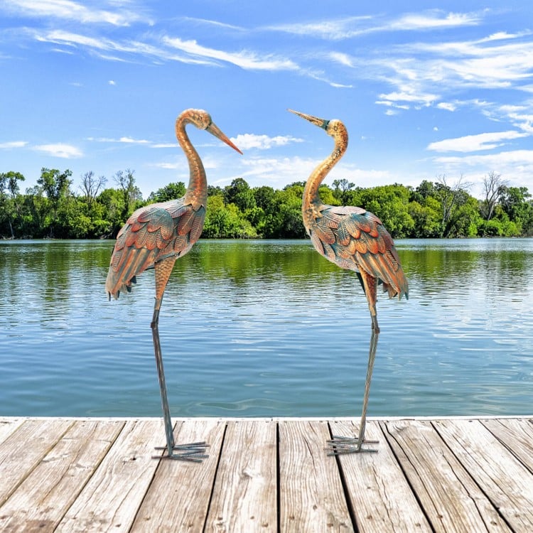 Set of 2 metal crane garden statues with U-shaped stakes, featuring detailed feathers for charming outdoor decoration.