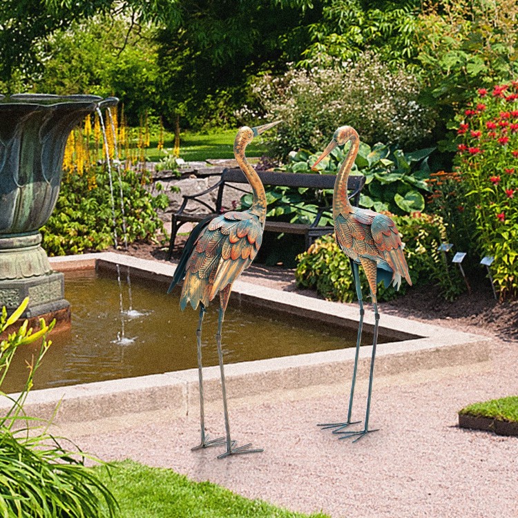 Set of 2 standing metal crane garden statues with detailed feathers, perfect for backyard or lakeside decoration.