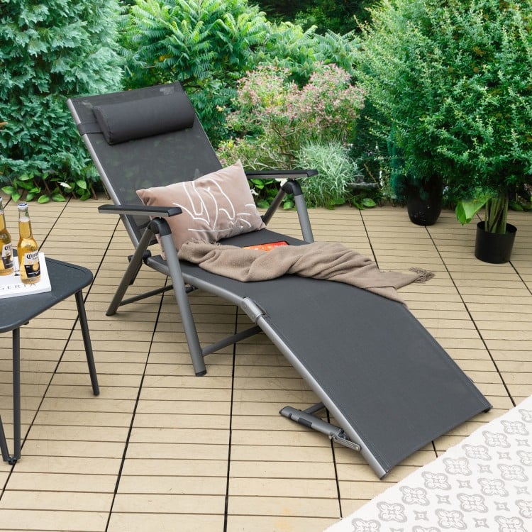Adjustable outdoor aluminum chaise lounge chair with quick-drying fabric, featuring a footrest for relaxation on a.