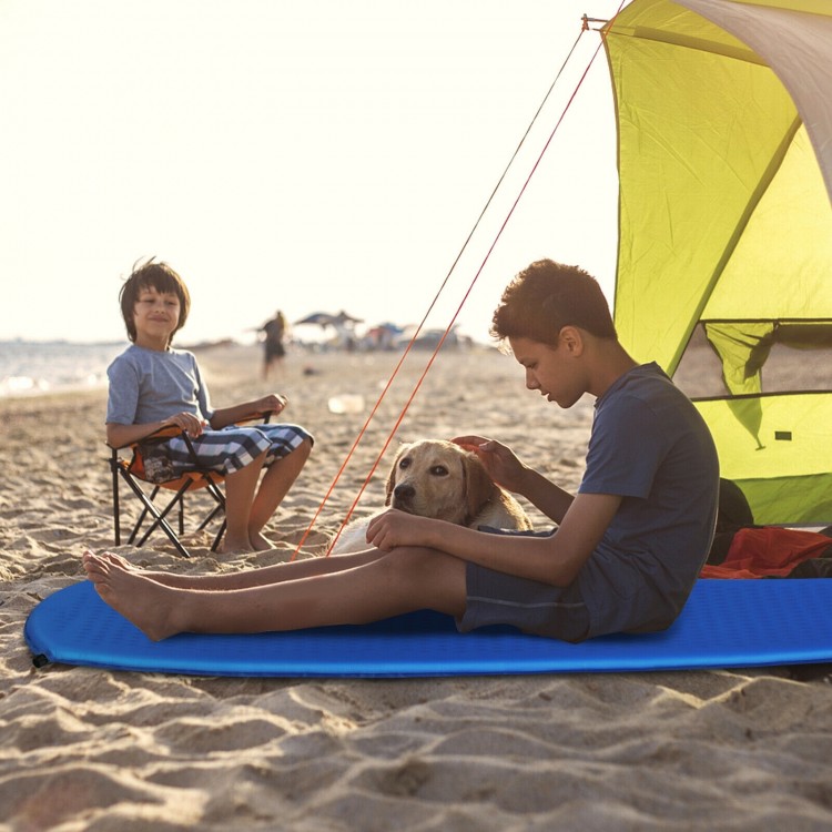 Blue inflatable sleeping pad on the beach, perfect for camping and outdoor use, featuring a waterproof surface.