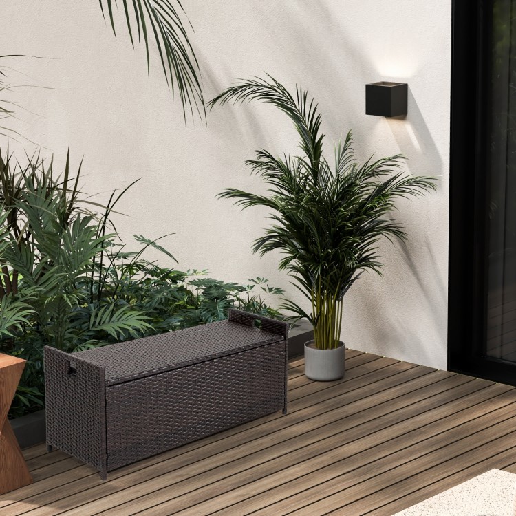 Patio storage bench with seat cushion, made of brown PE rattan, ideal for outdoor seating and storage solutions.