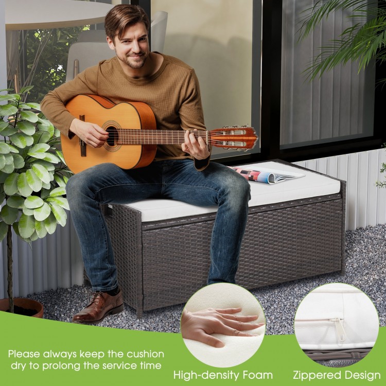 Patio storage bench with seat cushion, made of durable PE rattan, ideal for outdoor seating and storage.