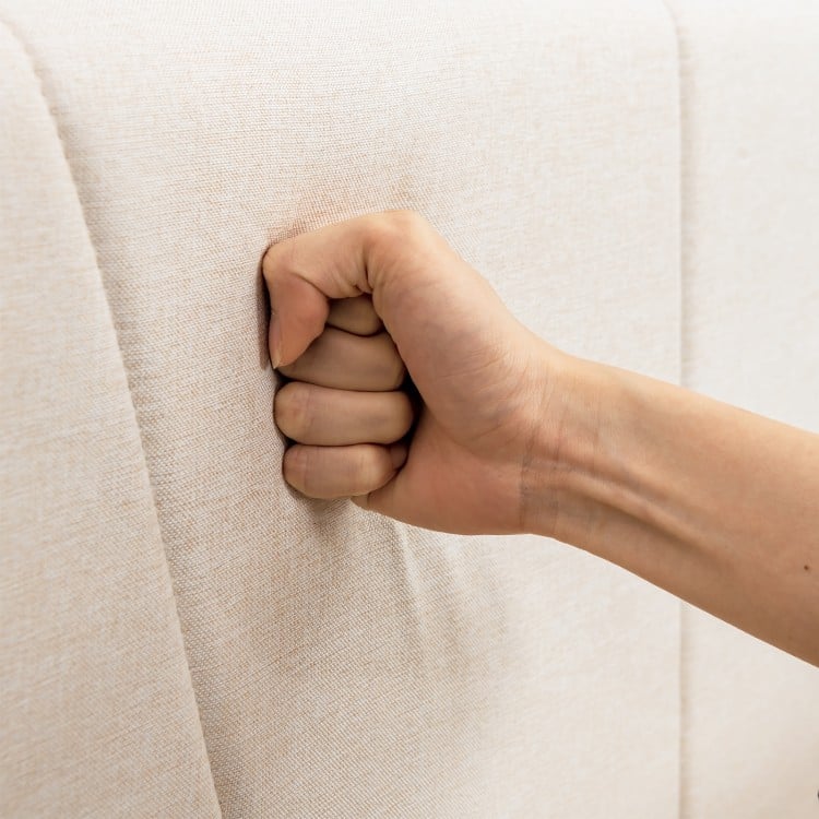 Close-up of the upholstered bed frame's geometric wingback headboard, featuring breathable linen fabric for comfort.
