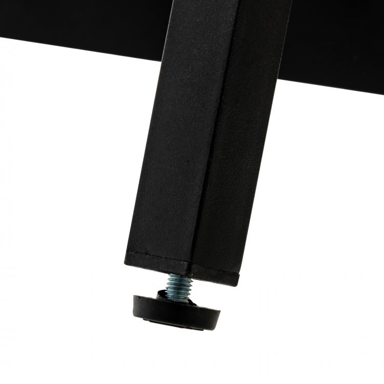 Close-up of the adjustable foot pad of a black upholstered bed frame for enhanced stability and noise reduction.