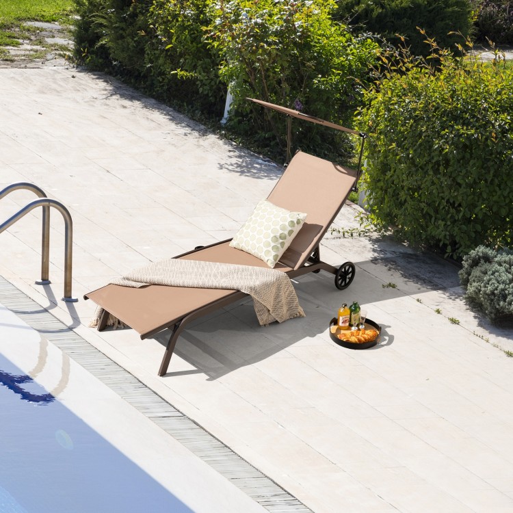 Adjustable brown chaise lounge chair with canopy and cup holder, perfect for poolside relaxation.