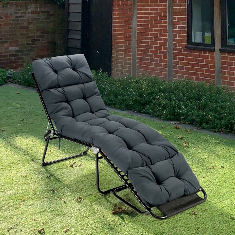 Gray outdoor lounge chaise cushion with string ties, made from waterproof polyester for garden or poolside use.