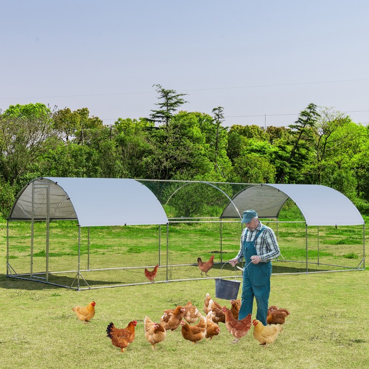 Large metal chicken coop with cover, featuring a sturdy galvanized frame and spacious design for chickens in a backyard.