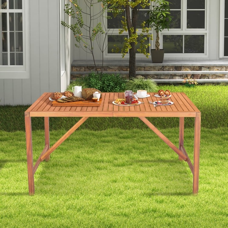 Rectangular 55-inch acacia wood dining table with slatted top and umbrella hole, perfect for outdoor gatherings.