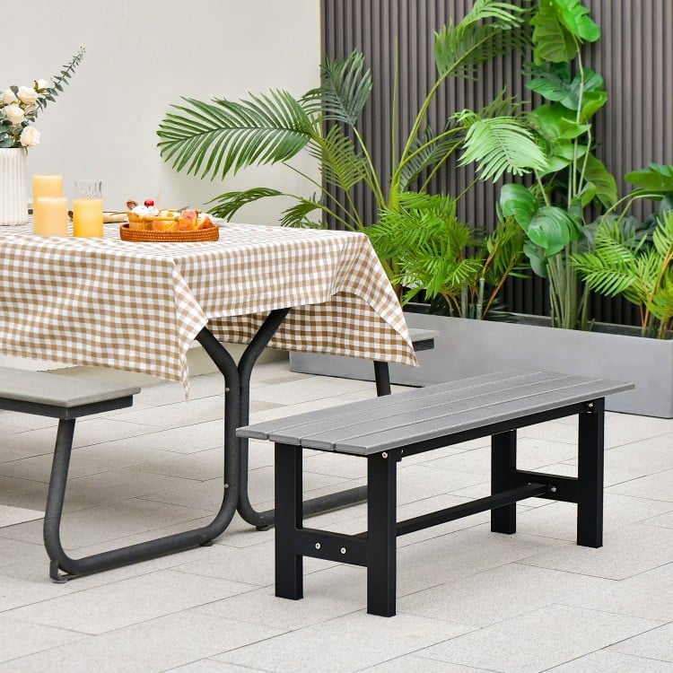 Gray 47-inch outdoor bench with slatted seat and plastic-coated iron frame, perfect for patio or garden seating.