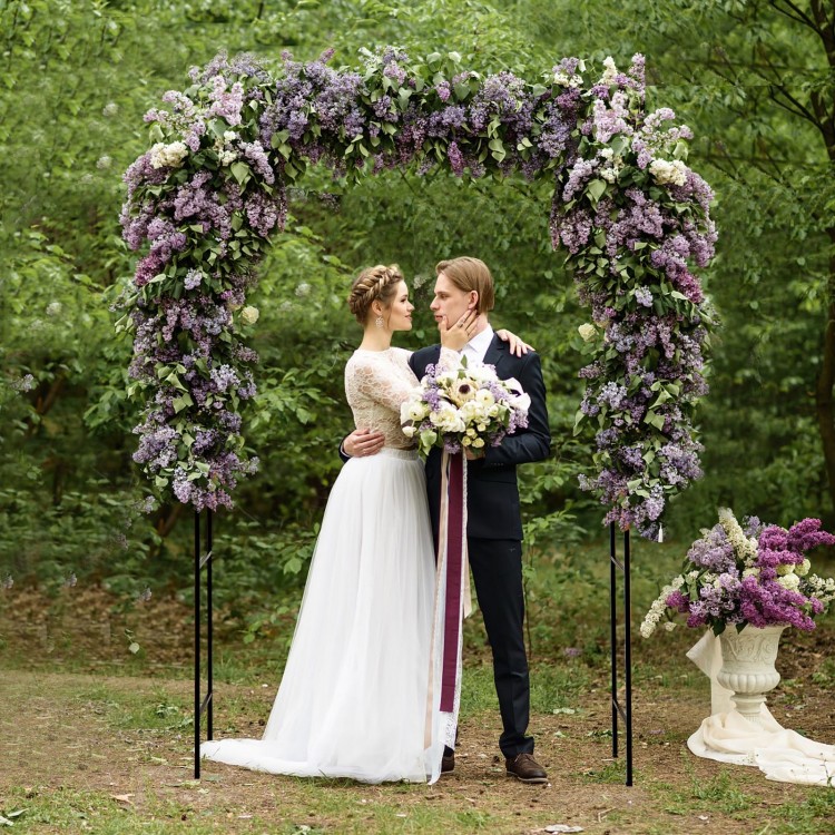 Black garden arch arbor trellis with a lockable gate, ideal for outdoor events and plant support in gardens.