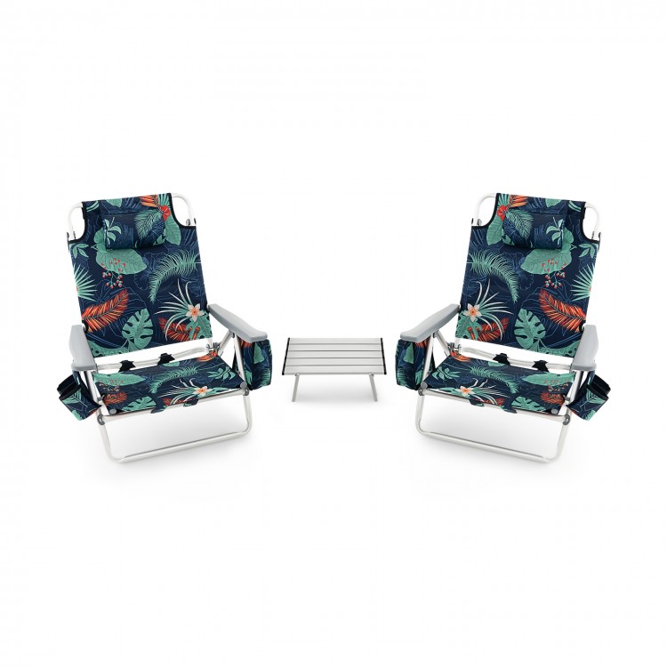 Two reclining beach chairs with tropical print and a folding side table, perfect for outdoor relaxation and convenience.
