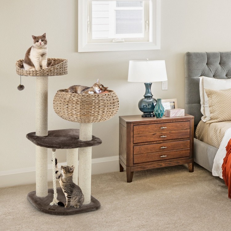 Rattan cat tree with napping perch, featuring sisal posts, hanging toys, and soft cushions for comfortable lounging.