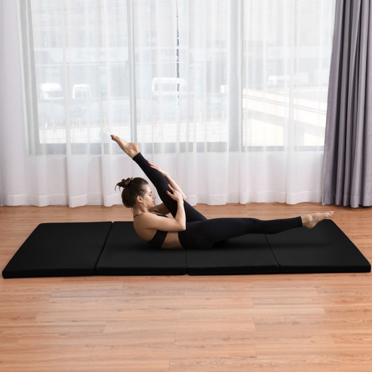 Folding black gymnastics mat for exercise, yoga, and dance, featuring four panels and a hand carry belt for portability.