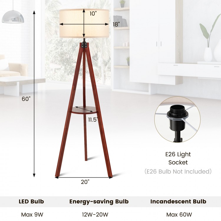 Tripod floor lamp with brown rubber wood base and flaxen lampshade, featuring E26 socket and round shelf for storage.