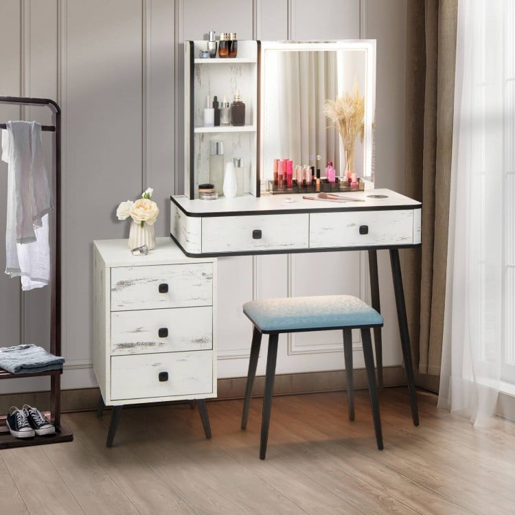 Vanity makeup table set in white with LED lighted mirror, drawers, and cushioned stool for organized beauty essentials.