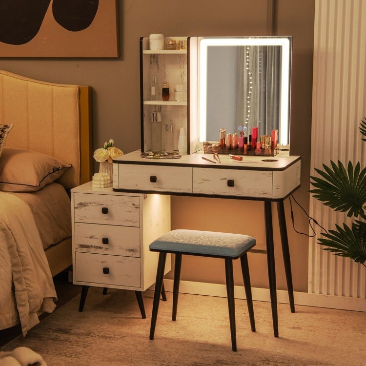 Cushioned stool included with vanity makeup table set, featuring LED lighted mirror and ample storage for cosmetics.
