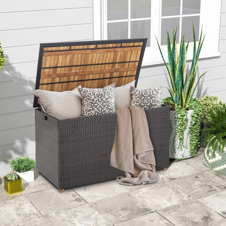 Rattan storage box with acacia wood top, featuring a zippered liner, ideal for patio side table use and outdoor storage.