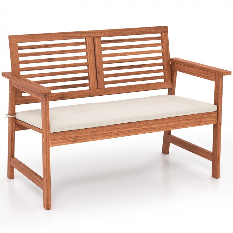 Solid wood patio bench with backrest and cushion, designed for two, perfect for backyard or poolside relaxation.