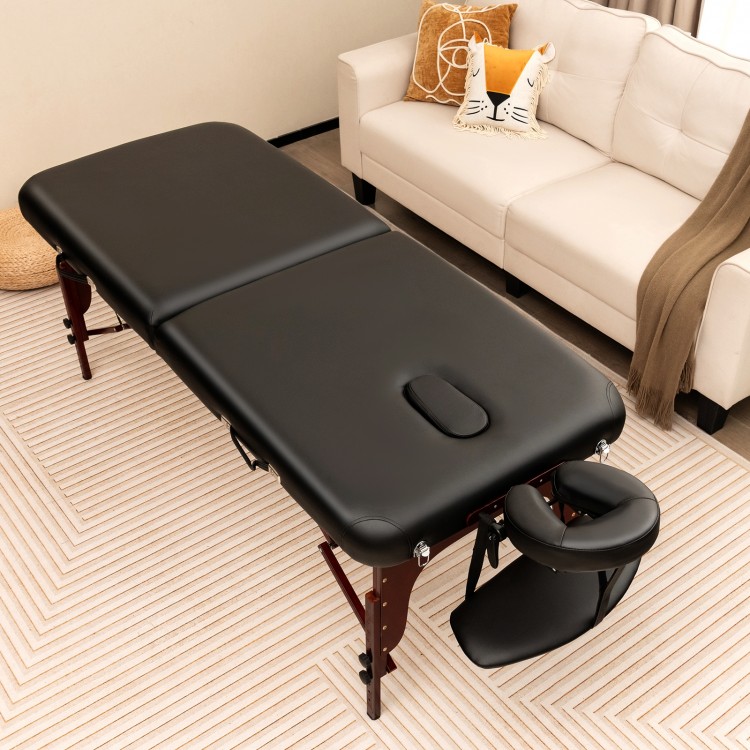 Folding massage table in black with height-adjustable beech wood frame, featuring memory foam for ultimate comfort.