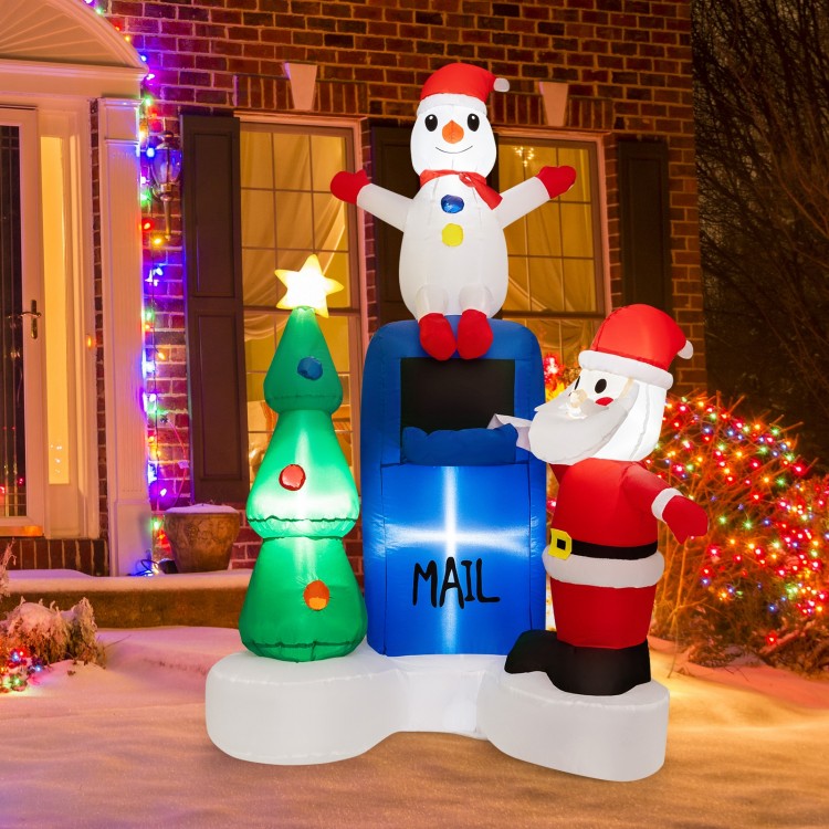 Lighted 6-foot inflatable Christmas scene featuring Santa Claus, snowman, and tree, perfect for outdoor holiday decor.