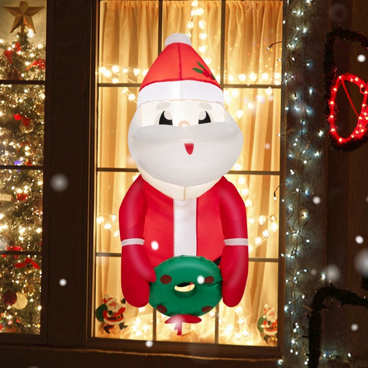 Lighted inflatable Santa Claus with wreath, 3.3 feet tall, perfect for festive indoor and outdoor Christmas decoration.