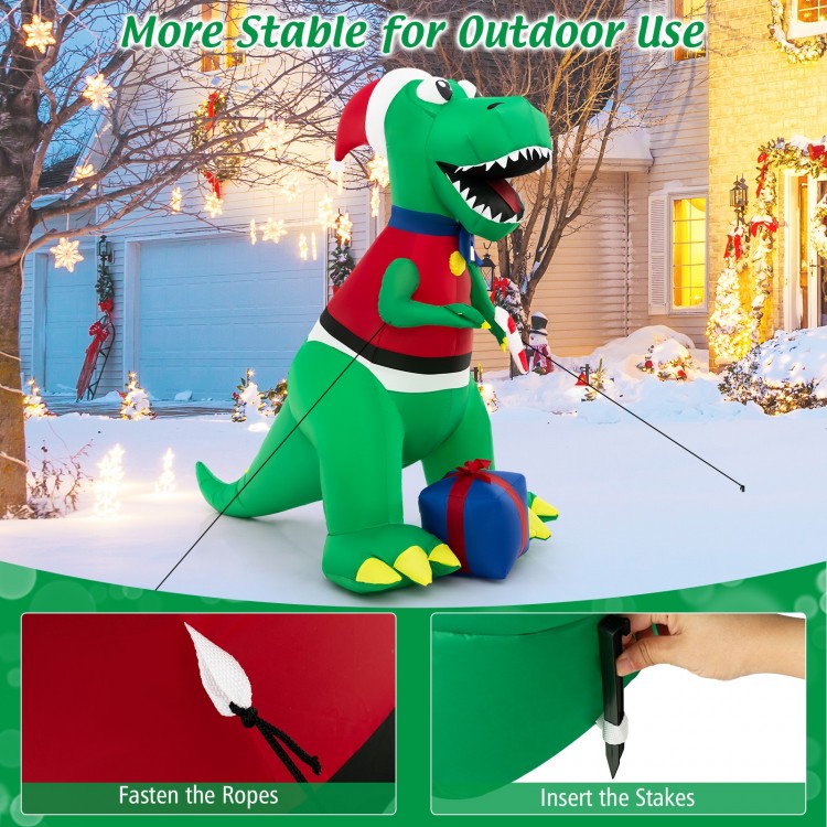 6FT inflatable dinosaur Christmas decoration with LED lights, featuring a Santa hat and gift boxes for festive outdoor.