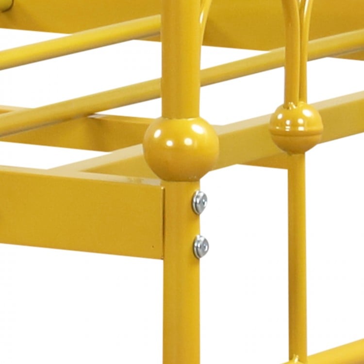 Close-up of the golden metal daybed frame showcasing reinforced connections and lockable wheels for stability and.