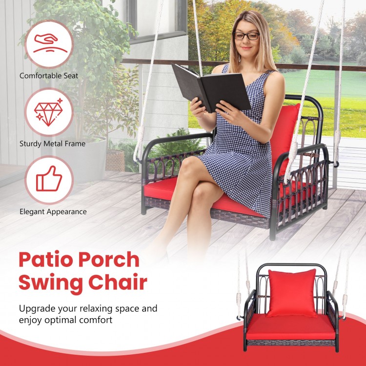 Patio rattan porch swing chair with red cushions, featuring a sturdy metal frame for backyard relaxation.