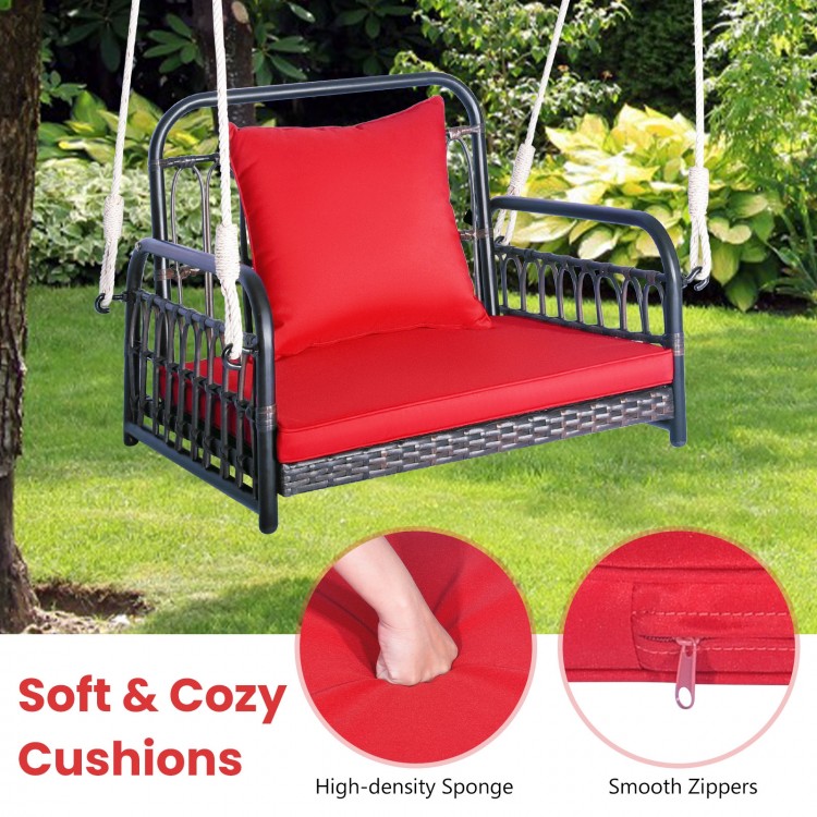 Patio rattan swing hammock chair with red cushions, featuring a durable metal frame for backyard relaxation.