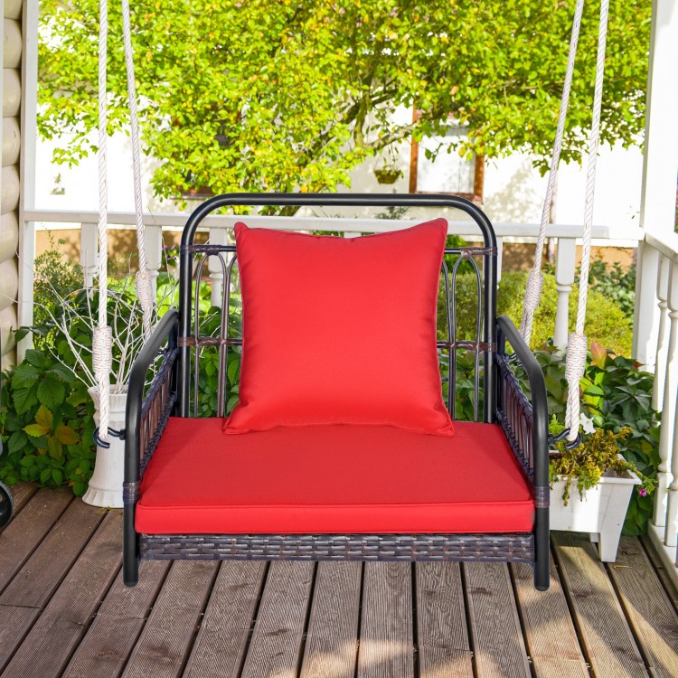 Patio rattan porch swing hammock chair with red seat cushion, featuring a durable metal frame for backyard relaxation.