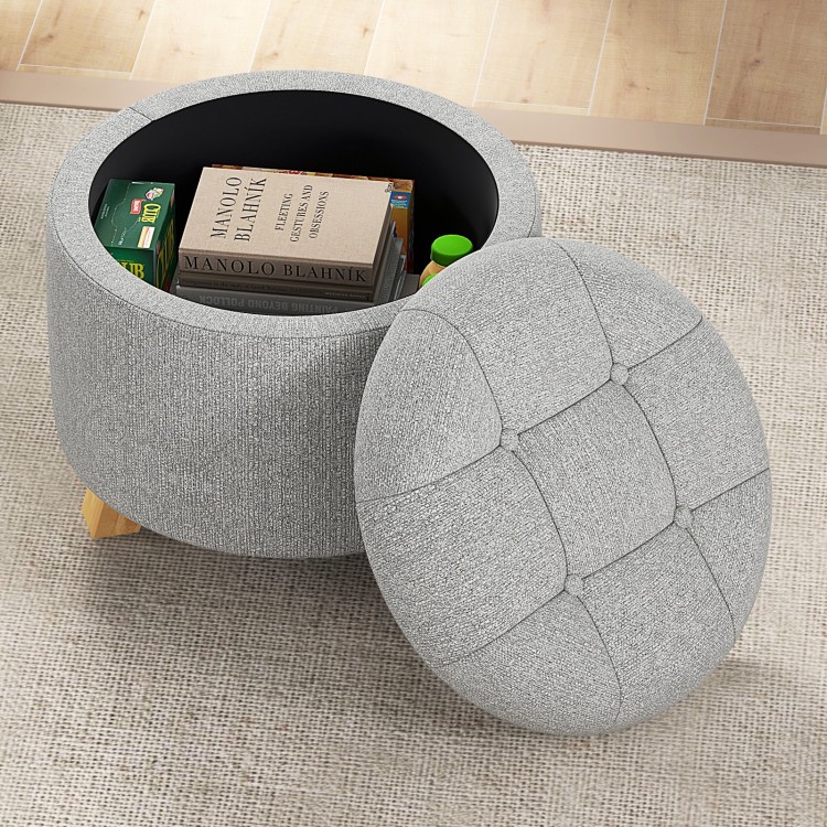 Round gray upholstered ottoman with storage space, cushioned seat, and solid rubber feet for versatile use.