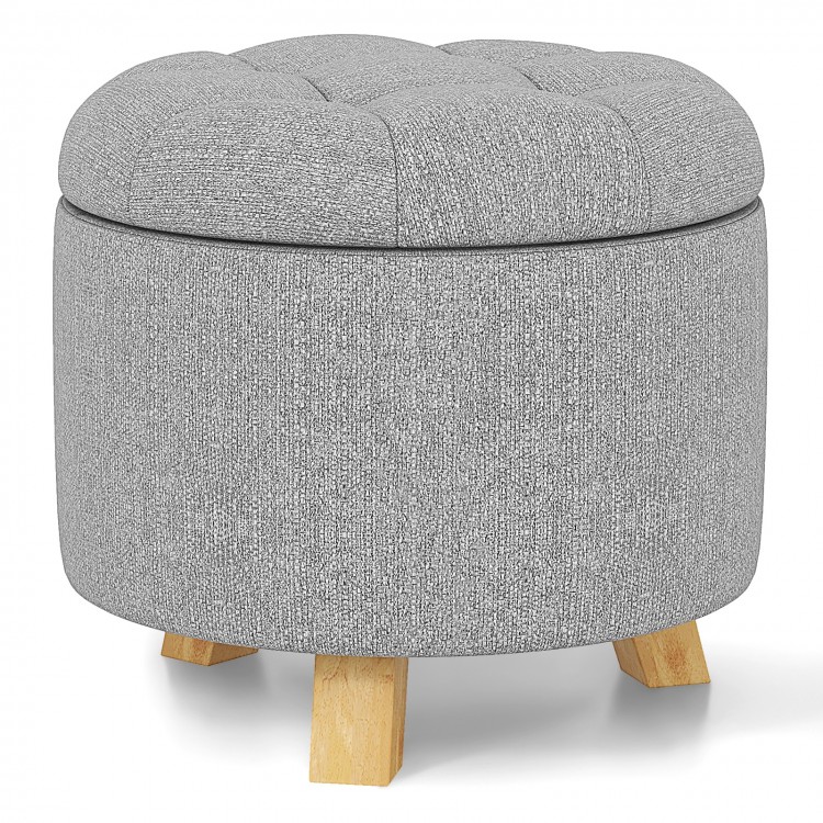 Round gray upholstered ottoman with solid rubber feet, featuring cushioned seat and storage space for versatile use.