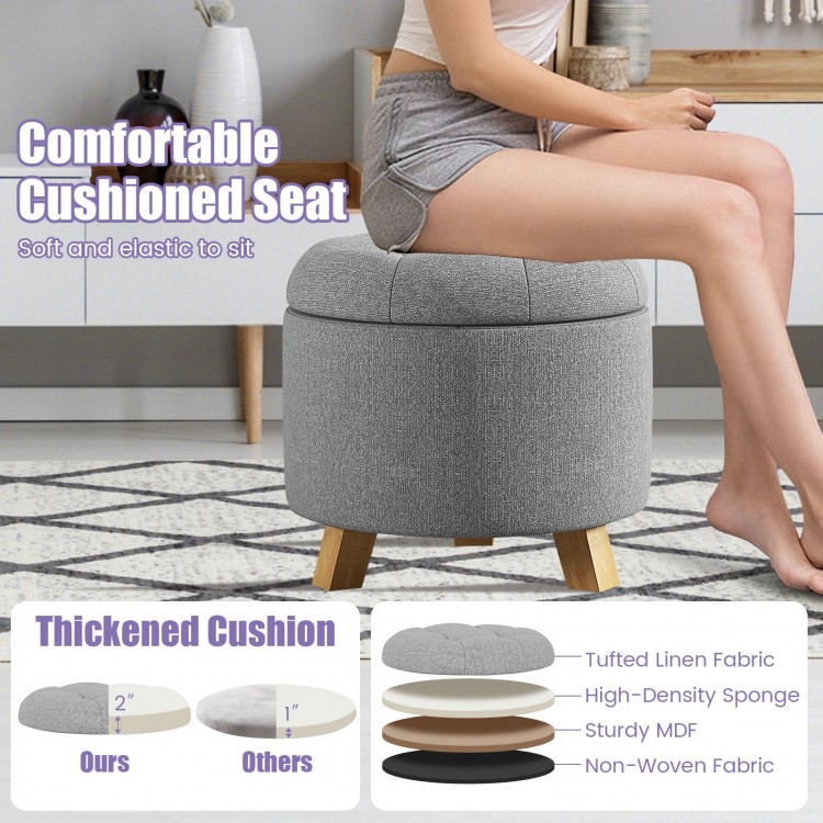 Round gray upholstered ottoman with cushioned seat, solid rubber feet, and storage space for versatile use.