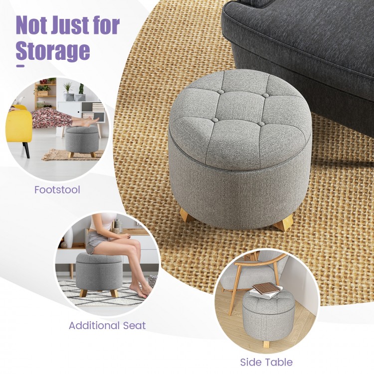 Round gray upholstered ottoman with solid rubber feet, offering storage and versatile use as a footstool or side table.