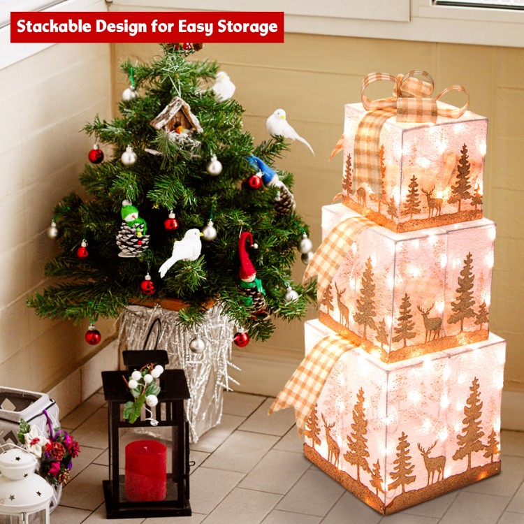 Stacked set of 3 lighted Christmas gift boxes with warm white lights, featuring a charming silhouette pattern for.