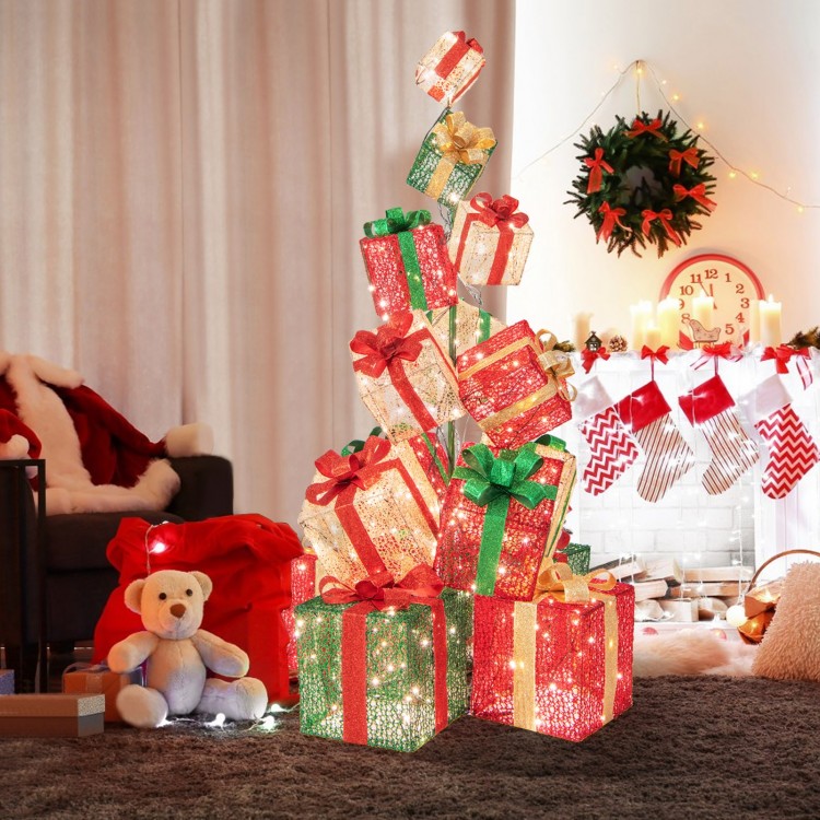 Colorful stacked lighted Christmas gift boxes with vibrant bows and warm white lights, creating a festive atmosphere.