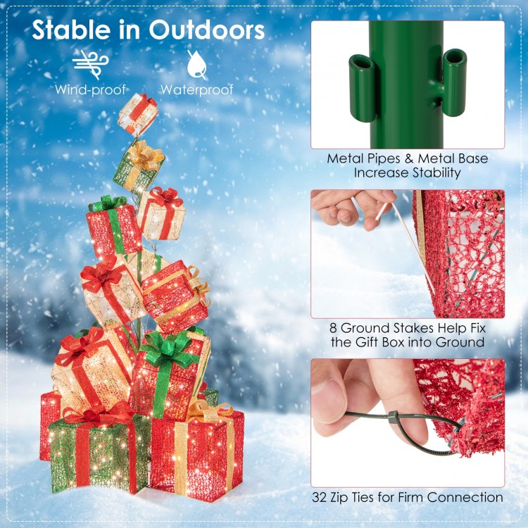 Stacked lighted Christmas gift box tower with 450 warm white lights, featuring metal base and 8 ground stakes for.