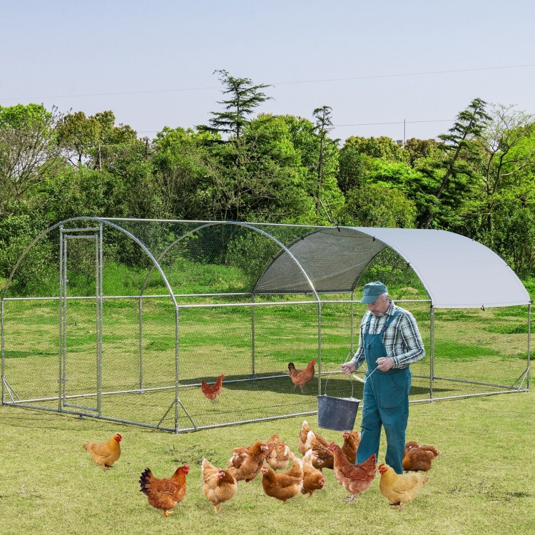 Large metal chicken coop with galvanized steel frame and waterproof cover, ideal for backyard poultry protection.