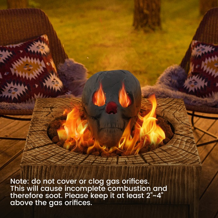 Realistic black skull fire pit decoration with flames escaping from eyes, perfect for Halloween ambiance and spooky.