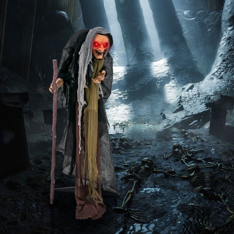 Life-size animatronic witch with red eyes and posable arms, perfect for Halloween decorations and haunted houses.