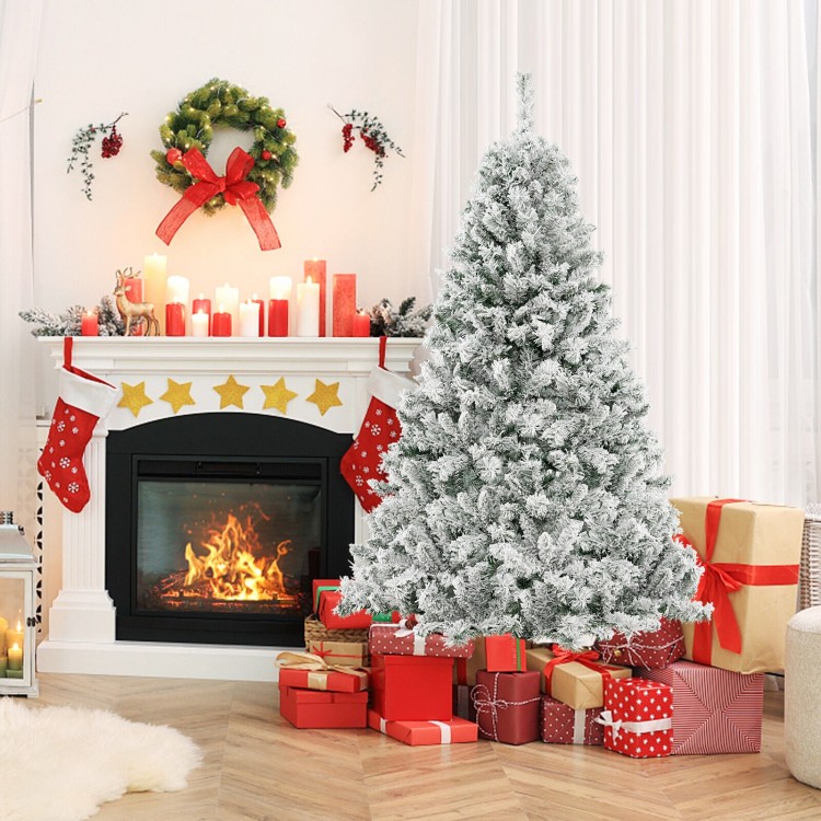 Snowy 6-foot artificial Christmas tree with warm white LED lights, surrounded by festive gifts and a cozy fireplace.