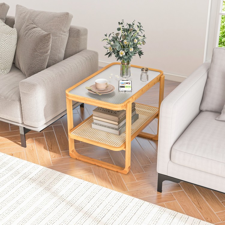 2-tier bamboo side table with glass top, featuring a rattan shelf for storage, perfect for living room or bedroom use.