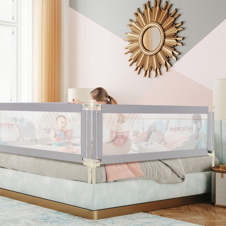 Vertical lifting baby bed rail with cute pattern, adjustable height, and safety lock, designed for various bed types.