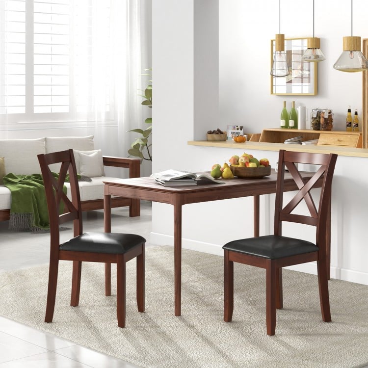 Set of 2 wooden dining chairs with padded black seats and rubber wood legs, perfect for kitchen or dining room use.