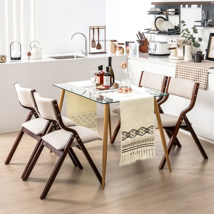 Wooden folding dining chairs with padded linen seats, compact design for space-saving in living room or cafe settings.