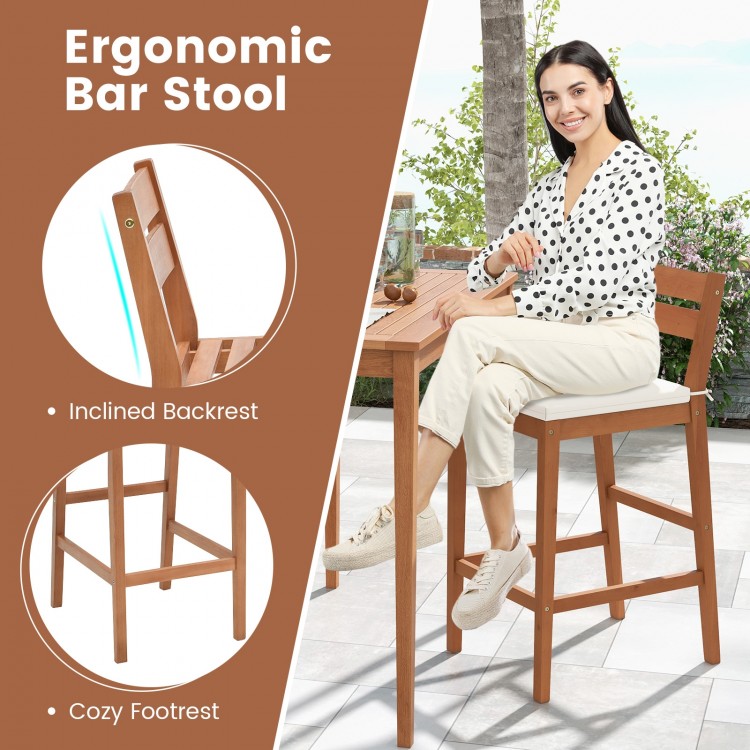 Outdoor wood bar stool with ergonomic design, inclined backrest, and soft off-white cushion for comfort and stability.